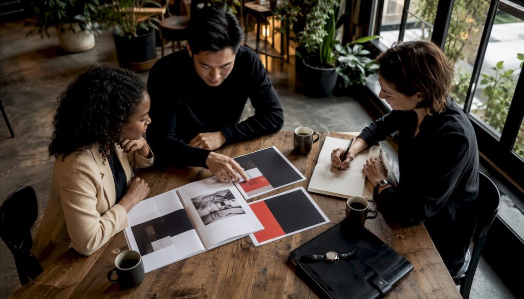 How to Compete With Established Luxury Brands: A Tactical Playbook Team discussing luxury brand strategy in office